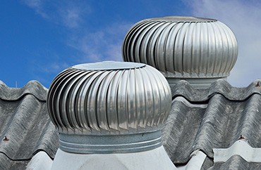 Two metal vents on the roof of a building in Michigan.