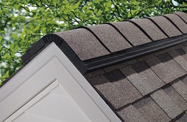 The MI improvement of a home featuring shingles on its roof.