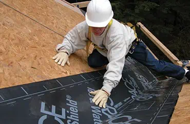 A man is working on the roof of a home in Michigan.