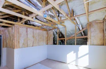 A room that is being remodeled with wood framing, insulation, and exterior.