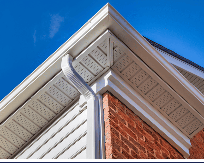 A professional image of a gutter against a blue sky, showcasing home improvement.