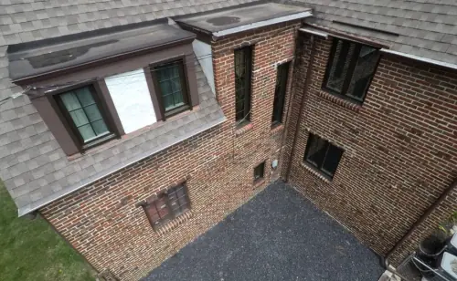 An aerial view of the roof of a brick home.