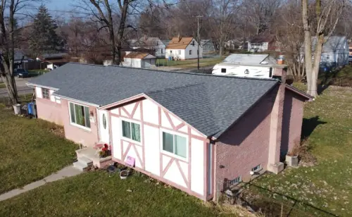 An aerial view of a home in Michigan with a pink roof.