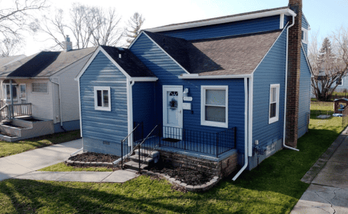 A blue house in a Michigan neighborhood.