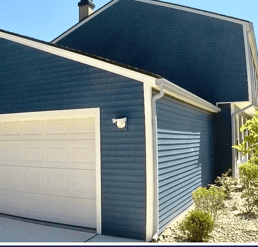 A home with blue siding and a garage door.