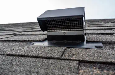 A vent hood on the roof of a residential roofing project.
