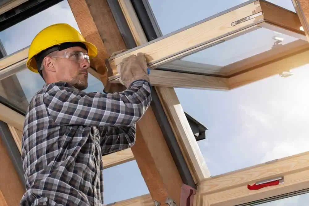 Home improvement contractor installing replacement windows in a residential home