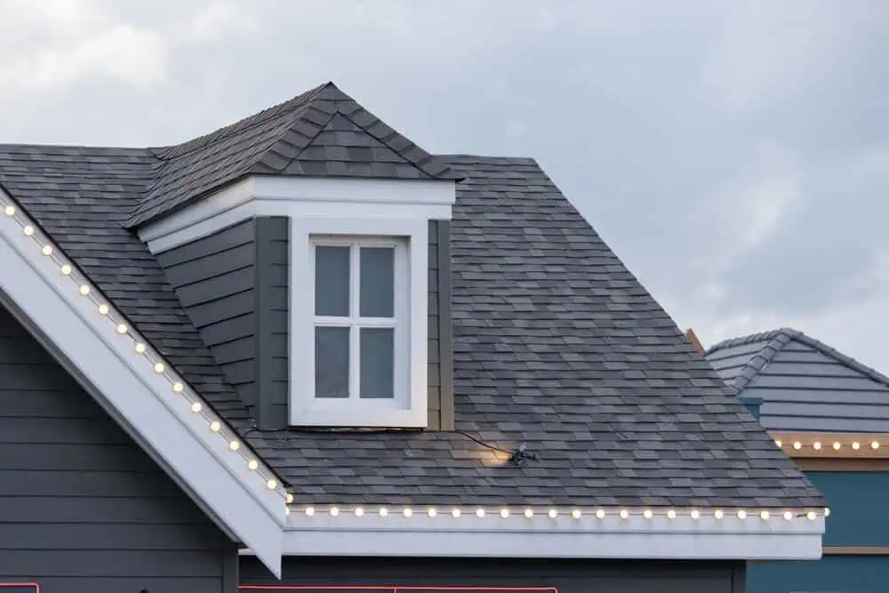 A dormer on a well-maintained roof with clean, gray shingles.