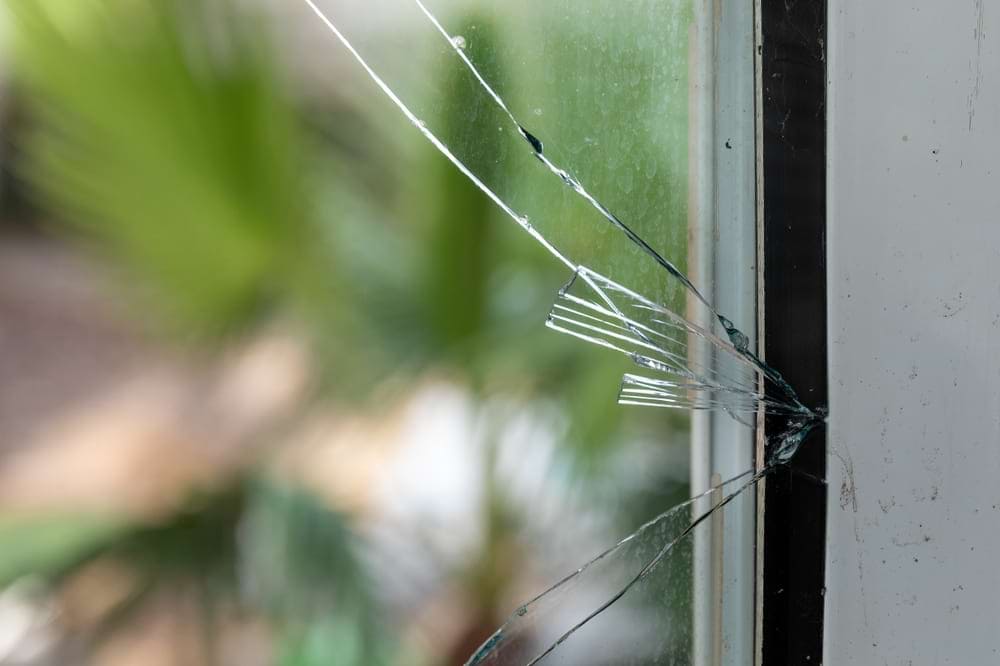 A large crack starting to spiderweb on a window glass