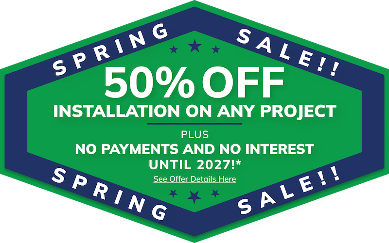 Green and blue hexagonal sign advertises 50% off Michigan home remodeling services.